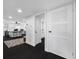 Hallway view leading to the modern kitchen and laundry room, featuring dark hardwood floors at 100 Oakmont Ln # 802, Belleair, FL 33756