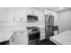 Bright kitchen with stainless steel appliances and white cabinets at 100 Oakmont Ln # 802, Belleair, FL 33756