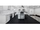 Kitchen featuring white cabinets and quartz countertops, stainless appliances and a large island at 100 Oakmont Ln # 802, Belleair, FL 33756