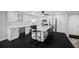 Updated kitchen with white cabinets and quartz countertops, stainless appliances and a large island at 100 Oakmont Ln # 802, Belleair, FL 33756