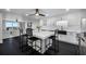 Modern kitchen with dark floors, an island with seating, and stainless steel appliances at 100 Oakmont Ln # 802, Belleair, FL 33756