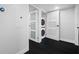 Conveniently located laundry area with a stackable washer and dryer concealed behind a sliding door at 100 Oakmont Ln # 802, Belleair, FL 33756