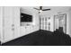A modern living room with a ceiling fan and an entertainment center at 100 Oakmont Ln # 802, Belleair, FL 33756