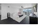 Bright living room with modern furnishings, access to a balcony, and city views, offering a stylish and comfortable living space at 100 Oakmont Ln # 802, Belleair, FL 33756