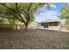 The home has a spacious backyard with mature trees and a fenced perimeter at 105 1St Se Ave, Lutz, FL 33549