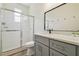Modern bathroom featuring a glass shower, sleek gray vanity, and a frameless mirror at 105 1St Se Ave, Lutz, FL 33549