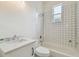 Bathroom showcases a tub with tiled backsplash, a modern sink, and sleek fixtures at 105 1St Se Ave, Lutz, FL 33549