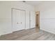 Bedroom with double closets, light-colored floors, and an open doorway at 105 1St Se Ave, Lutz, FL 33549