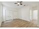 A spacious bedroom features double closets, ceiling fan, and wood-style laminate flooring at 105 1St Se Ave, Lutz, FL 33549