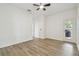 Well-lit bedroom with wood-style laminate flooring and sliding glass door to outdoor patio at 105 1St Se Ave, Lutz, FL 33549