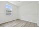 Bright bedroom with large window offering plenty of natural light and light, wood-look flooring at 105 1St Se Ave, Lutz, FL 33549