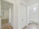 Hallway showcases a linen closet and a bathroom with black and white checkered tiles at 105 1St Se Ave, Lutz, FL 33549