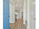 Bright hallway with modern flooring, leading to the main living areas and bedrooms at 105 1St Se Ave, Lutz, FL 33549