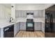 Updated kitchen with gray cabinets, modern appliances, and ample countertop space at 105 1St Se Ave, Lutz, FL 33549
