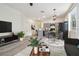 Open-concept living area with contemporary furniture, dining space, and modern kitchen at 105 1St Se Ave, Lutz, FL 33549