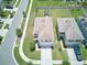 Aerial view of home with a well-maintained lawn, fenced backyard, and outdoor patio area at 10826 Trailing Vine Dr, Tampa, FL 33610
