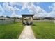 Landscaped backyard with outdoor seating area at 10826 Trailing Vine Dr, Tampa, FL 33610