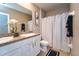 Bathroom featuring a double vanity, commode, and tub with shower at 10826 Trailing Vine Dr, Tampa, FL 33610