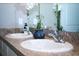 Close up on a bathroom with a double sink vanity and modern, elegant fixtures at 10826 Trailing Vine Dr, Tampa, FL 33610