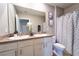 Bathroom featuring a double vanity, commode, and tub with shower at 10826 Trailing Vine Dr, Tampa, FL 33610