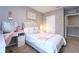 Bright bedroom featuring a well-made bed, clean design and a fun vanity area at 10826 Trailing Vine Dr, Tampa, FL 33610