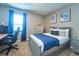 Bedroom with a blue bedspread and decorations at 10826 Trailing Vine Dr, Tampa, FL 33610