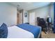 Bedroom with desk area and blue bedspread at 10826 Trailing Vine Dr, Tampa, FL 33610