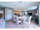 Well-lit dining space with comfortable seating, adjacent to an open kitchen and living area at 10826 Trailing Vine Dr, Tampa, FL 33610