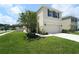 Charming two-story home with a well-kept lawn, flower beds and an attached two-car garage at 10826 Trailing Vine Dr, Tampa, FL 33610