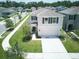 Well-maintained two-story home with a two-car garage and a manicured lawn in a vibrant neighborhood at 10826 Trailing Vine Dr, Tampa, FL 33610