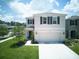 Charming two-story home featuring a well-manicured lawn and an attached two-car garage at 10826 Trailing Vine Dr, Tampa, FL 33610