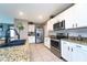 Modern kitchen showcasing stainless steel appliances, white cabinets, and granite countertops at 10826 Trailing Vine Dr, Tampa, FL 33610