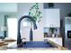 Close up on kitchen sink featuring black gooseneck faucet with view of kitchen and cabinetry at 10826 Trailing Vine Dr, Tampa, FL 33610