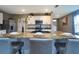 Beautiful kitchen island with granite countertop, stainless steel appliances and seating for three at 10826 Trailing Vine Dr, Tampa, FL 33610