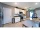 Well-appointed kitchen features white cabinets, stainless steel appliances, and granite countertops at 10826 Trailing Vine Dr, Tampa, FL 33610