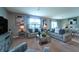 Bright living room with neutral tones including carpet, curtains, sofas and decorative pillows at 10826 Trailing Vine Dr, Tampa, FL 33610