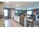 Kitchen island looking out to living room and dining area with neutral tones and window light at 10826 Trailing Vine Dr, Tampa, FL 33610