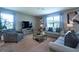 Comfortable living room featuring neutral tones, plush seating, and abundant natural light at 10826 Trailing Vine Dr, Tampa, FL 33610