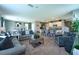 Open-concept living space with modern kitchen, dining area, and comfortable seating arrangement at 10826 Trailing Vine Dr, Tampa, FL 33610