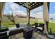 Outdoor pergola featuring comfortable seating, a ceiling fan and accent lighting for enjoyable evenings at 10826 Trailing Vine Dr, Tampa, FL 33610