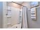 Shower with shower curtain and wall shelves at 10826 Trailing Vine Dr, Tampa, FL 33610