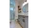 Well-lit bathroom featuring a glass shower, stylish vanity, and modern fixtures at 11606 Quiet Forest Dr, Tampa, FL 33635