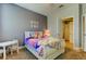 Bedroom with bed, neutral walls, and a peek into a bathroom with a shower at 11606 Quiet Forest Dr, Tampa, FL 33635