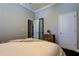 Cozy bedroom with hardwood floors, ensuite closet, and neutral color palette at 11606 Quiet Forest Dr, Tampa, FL 33635