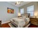 Bright bedroom with natural light, hardwood floors, and contemporary decor at 11606 Quiet Forest Dr, Tampa, FL 33635