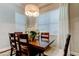 Dining area complete with a chandelier, large window, and classic furnishings at 11606 Quiet Forest Dr, Tampa, FL 33635