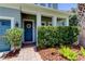 Inviting front entryway with blue door, brick pathway, and tidy landscaping at 11606 Quiet Forest Dr, Tampa, FL 33635