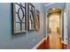 Stylish hallway featuring hardwood floors, wall decor, and arched doorway at 11606 Quiet Forest Dr, Tampa, FL 33635