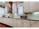 Spacious kitchen features granite counters, white cabinets and stainless appliances at 11606 Quiet Forest Dr, Tampa, FL 33635