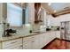 This kitchen features granite counters, stainless appliances, white cabinets, and tile backsplash at 11606 Quiet Forest Dr, Tampa, FL 33635